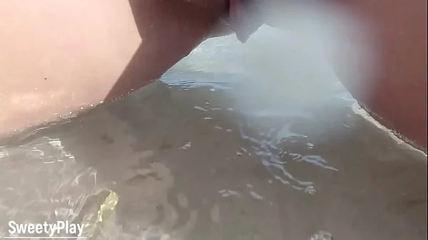 Shaved pussy peeing on public beach