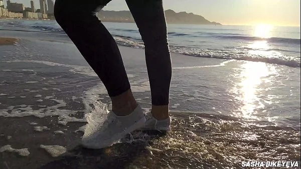 Wet shoot on a public beach with Crazy Model. Risky outdoor masturbation. Foot fetish. Pee in jeans.